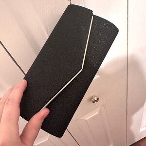 Black and Gold glitter sparkles clutch with gold chain. New condition.